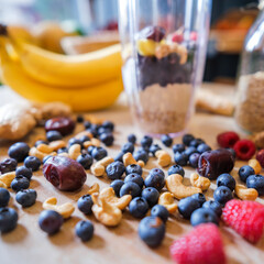 Healthy protein shake on table with fruits and vegetables ingredients around.