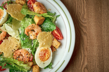 Salad with vegetables, tuna and boiled egg. Nicoise salad. Wooden background