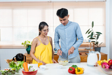 Asian husband and wife spend their free time together on vacation. Cook with your partner while pregnant. Free time in the kitchen The two seemed happy to spend their free time together.