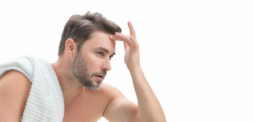 Banner of beauty male portrait of a beautiful man applying face cream. Moisturizing skincare cream for man. Mask for skin lifting and anti-aging effect. Beauty male face concept. Skincare and aging.