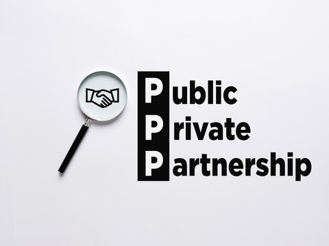 Magnifier magnifies the handshake agreement symbol with the word PPP Public Private Partnership.