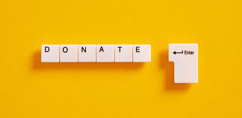 Online donation, charity and relief work concept. Computer keyboard keys with the word donate.