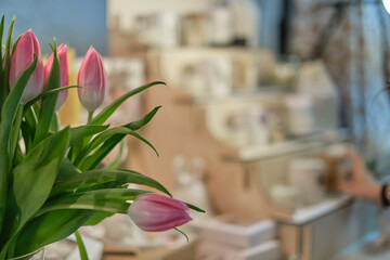 fresh bunch of tulips is beautifully contrasted against the out-of-focus backdrop of a charming...