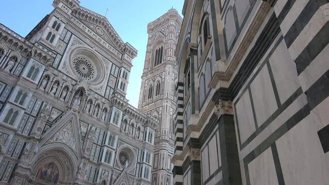 Florence, Italy, seen from below. Details of the cathedral and Giotto's bell tower. View of the Basilica of Santa Maria del Fiore. 4K footage