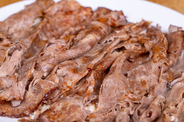 Meat doner kebab. Turkish doner kebab on wood floor. Turkish cuisine delicacies. Food tourism. Close up