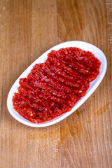 Chili paste. Hot snack prepared with pepper paste in a ceramic bowl. close up