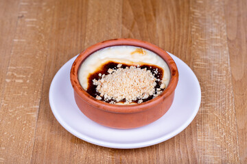 Hazelnut Rice Pudding Dessert. Rice pudding dessert made with milk and rice on a wood floor. Local name sutlac. close up