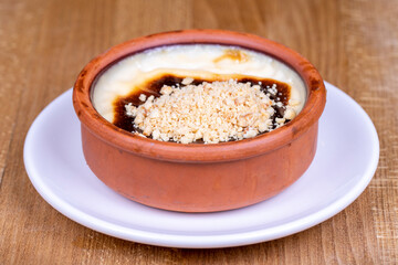 Hazelnut Rice Pudding Dessert. Rice pudding dessert made with milk and rice on a wood floor. Local name sutlac. close up