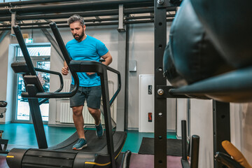 Man in blue tshirt exercising on a treadmill