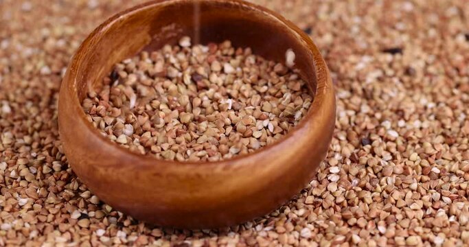 Poorly cleaned buckwheat groats for cooking porridge, a large amount of low-quality processing of buckwheat groats close-up