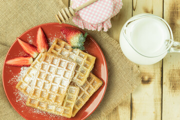 Fresh Belgian waffles with fruits, top view. Tasty breakfast