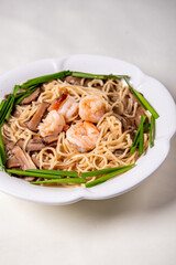 wok fried fu Zhou braised ee fu noodle bee hoon longevity noodle mee with seafood mushroom prawn egg meat and vegetables on wood table asian chinese halal food menu for restaurant