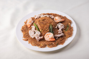 wok fried fu Zhou braised ee fu noodle bee hoon longevity noodle mee with seafood mushroom prawn egg meat and vegetables on wood table asian chinese halal food menu for restaurant