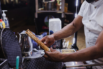 hand preparing Marquesitas mexican dessert traditional in Yucatan and Cancun Mexico in Latin America, Marquesita
