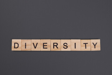 Diversity word from wooden blocks on gray background