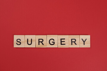Word Surgery from wooden letters on red background