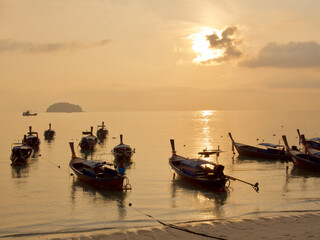 Small scale fisheries boat with sunset sky in Thailand 