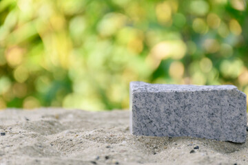 White geometric stone background. display podium for product  mockups  3d trade show display advertising, on sandy background blurred natural bokeh luxury modern luxury. Business for cosmetic display.