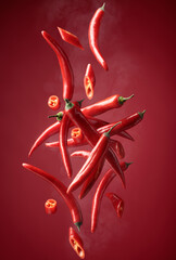 Steaming red pepper in motion on a red background.
