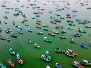Aerial shot of multi-colored boats at sea in Vietnam