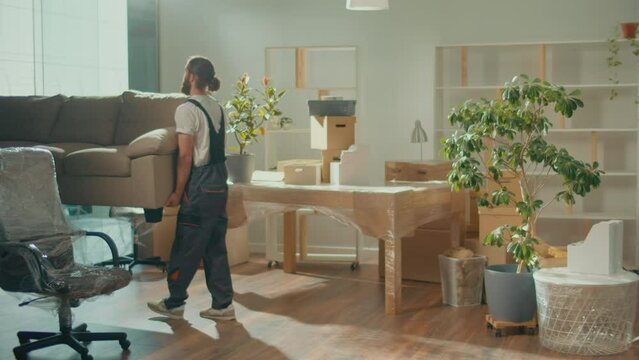 Workers of Moving Company With Uniforms Carefully Packing Furniture. Furniture and Equipment Disassembly and Assembly. Travel insurance. Team of Employee Workers Helps Customers to Relocation.
