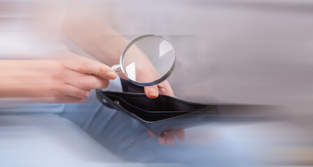 girl holding a magnifying glass and wallet