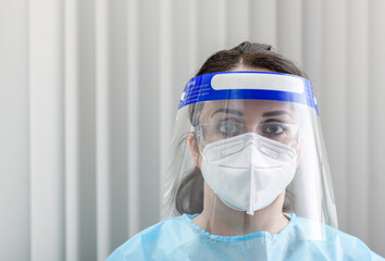Nurse's close-up portrait with protective glasses, N95 mask and face protection at hospital