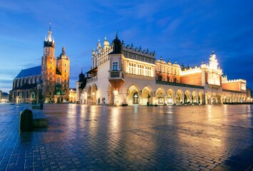 Fototapeta na wymiar St. Mary's Church in the evening with a city in the background, in Krakow, Poland