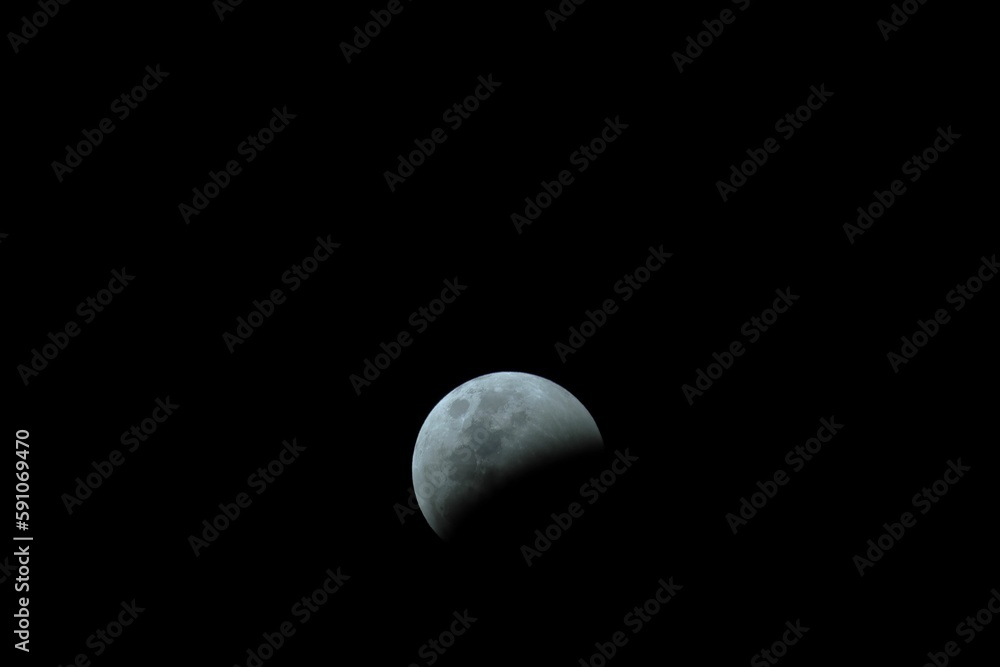 Poster beautiful view of a partial lunar eclipse before totality on a black background
