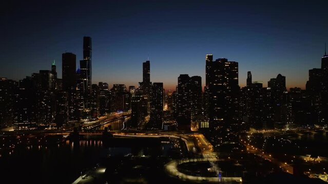 Aerial view in front of illuminated Streeterville, Chicago river and the New Eastside skyline