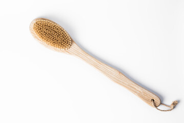 Wooden massage brush isolated on a white background. The concept of health care and body care