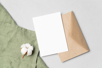 Invitation or greeting card mockup with cotton flowers and envelope