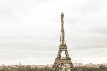 Aerial view of Eiffel Tower against white cloudy sky background in Paris, France