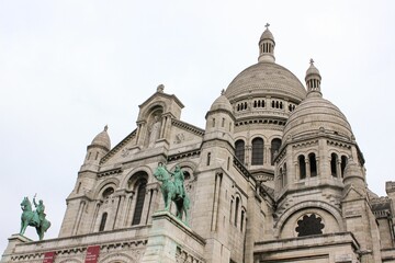 Fototapeta na wymiar Low angle shot of the Sacre-Coeur Basilica against white sky in Paris, France