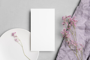 Wedding paper blank menu card mockup on white plate with flowers, empty mockup with copy space