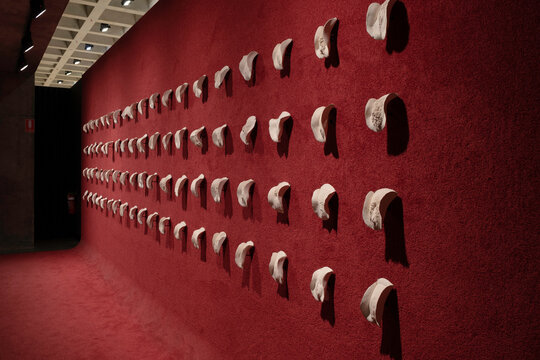 HOBART, TASMANIA, AUSTRALIA - MARCH 02 2023: Great Wall of Vagina, 151 porcelain vulvas sculpted from real women with carpeted red floor and wall, in MONA Museum of Old and New Art in Hobart