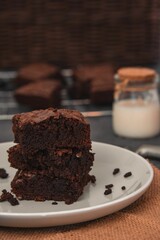 Selective focus of Chocolate brownie slice on white plate with blur background