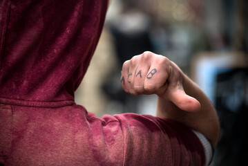 Closeup of acab tatoo on hand of young man in the street - 591073480