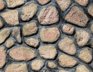 A wall of laid out stones as a background.