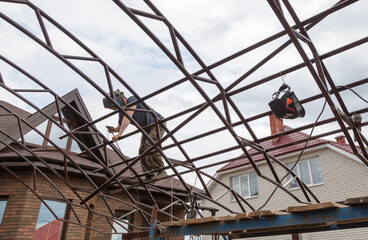 The worker installs the metal on the canopy.