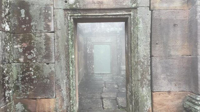 A foggy path through ancient ruins in Cambodia