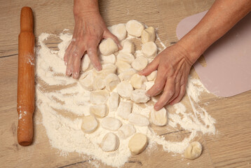 Dough with a rolling pin on the table.