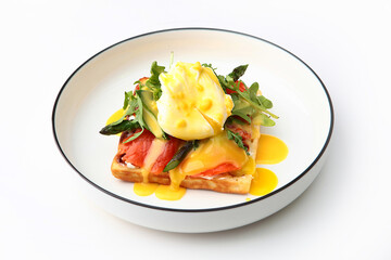 Fresh Viennese waffle with salted salmon and poached egg. Arugula and tomatoes. The concept of a healthy breakfast. Top view. Copy space. Isolated object. White background.