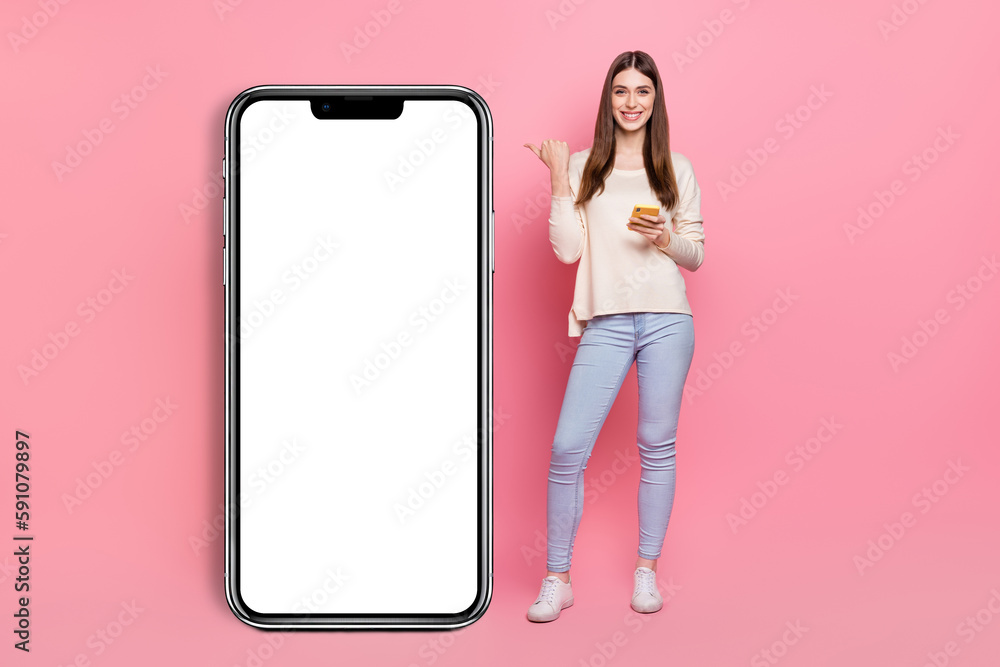Poster full length body size view of beautiful trendy girl using device showing copy space ad isolated over