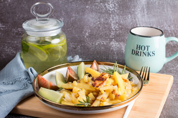 green tea with lime and mint in a glass jar with a plate of country fried potatoes. Homemade food, lunch