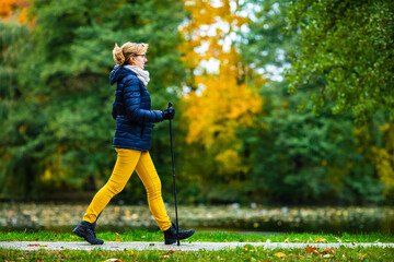 Nordic walking - woman training in city park
