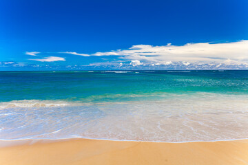 Sandy beach and beautiful tropical sea with blue sky.