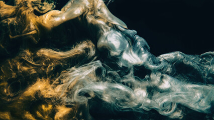 Color smoke. Ink water. Paint drop. Underwater mystery. Metallic gold silver blue glowing fluid splash cloud on dark black abstract art copy space background.