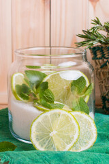 lime and mint with sugar in a glass jar. Tincture for fragrant green tea, Hot healthy drink in a cup