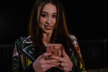 A young adult woman uses a mobile phone